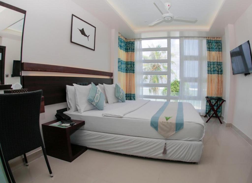 Відпочинок в готелі White Harp Beach Хулхумале Мальдіви